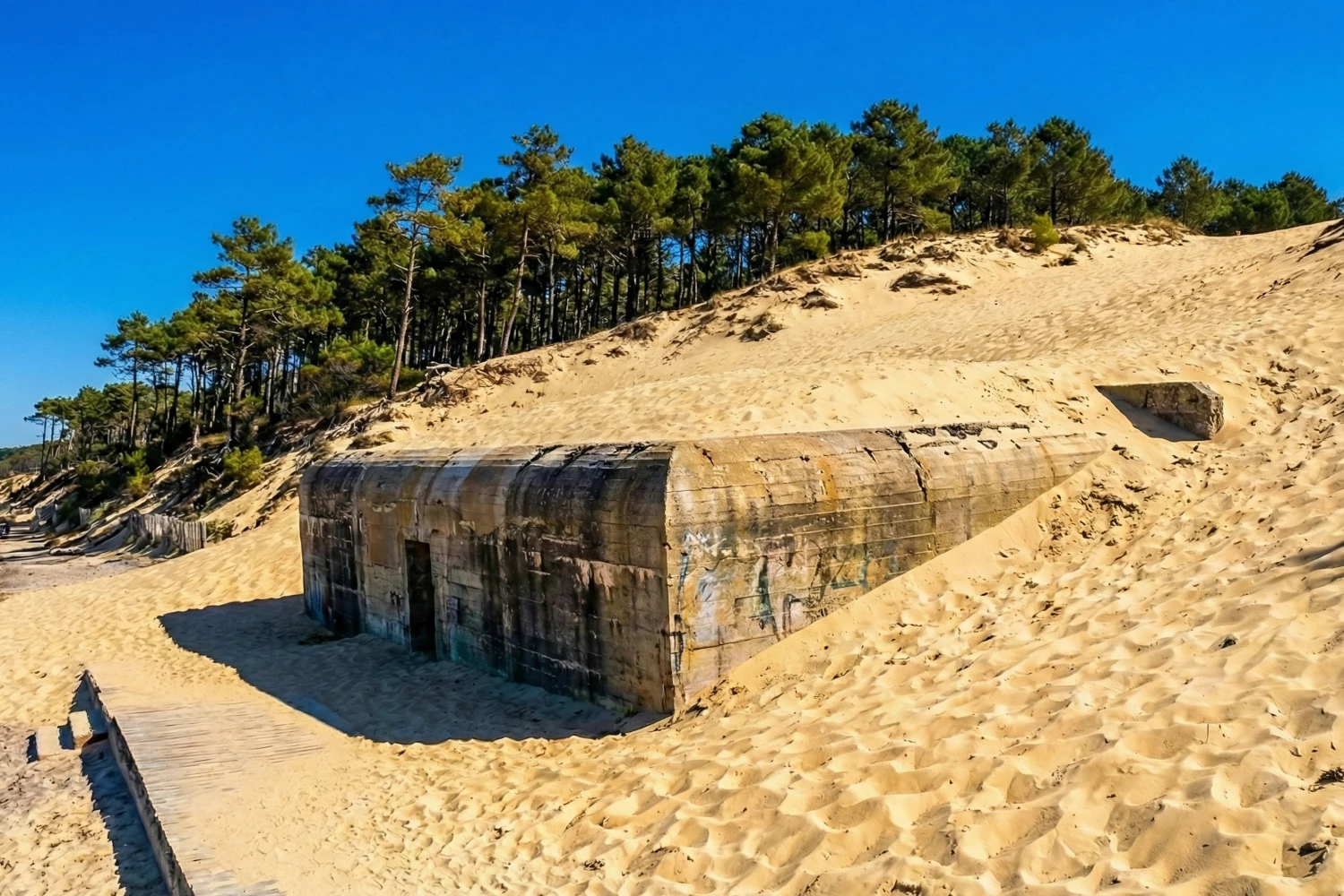 Vue sur un bunker recouvert de sable